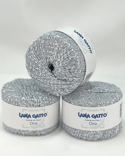 Three skeins of Lana Gatto yarn on a white background