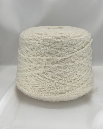 Spool of white yarn on a white background