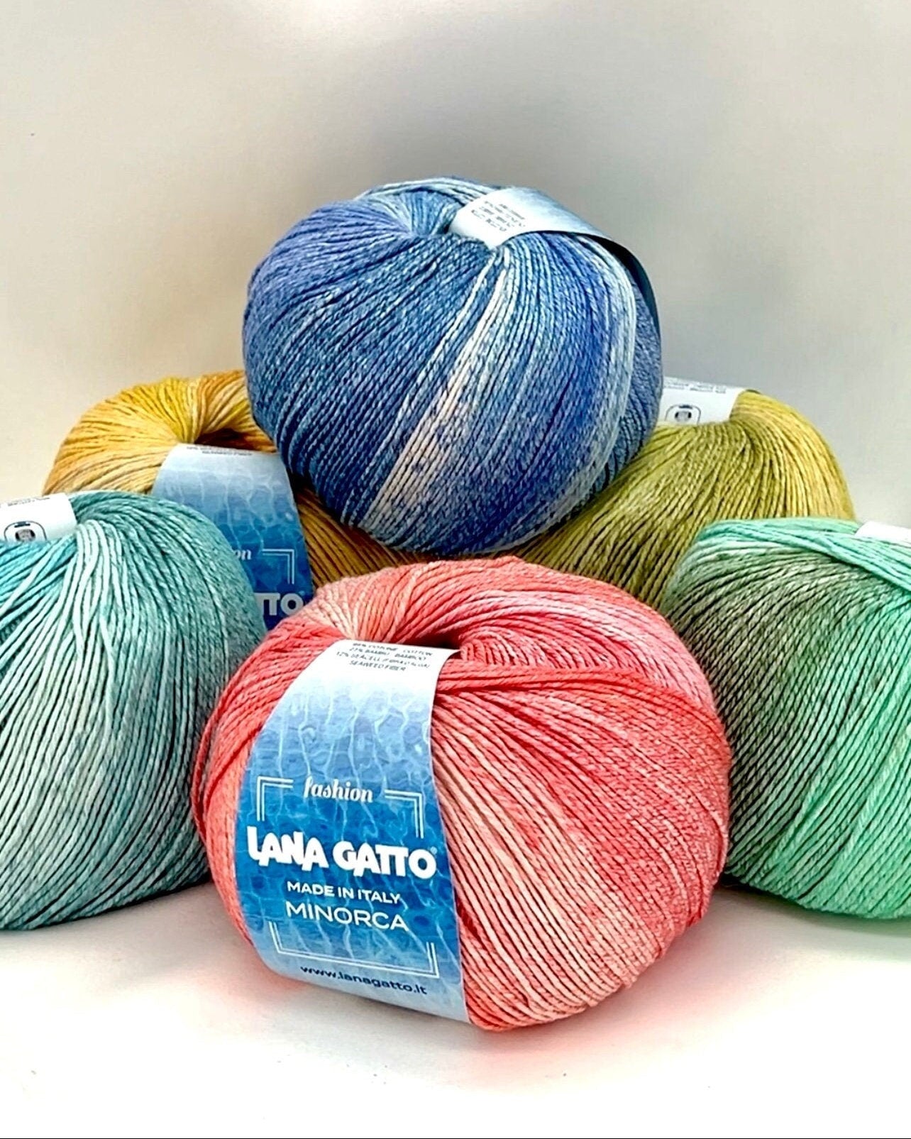 Luxury Italian designer yarn collection for iDOKNiT, featuring premium natural fibers on cones for professional hand-knit and machine-knitting projects.