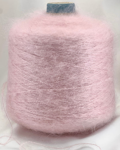 Pink yarn spool on a light gray background