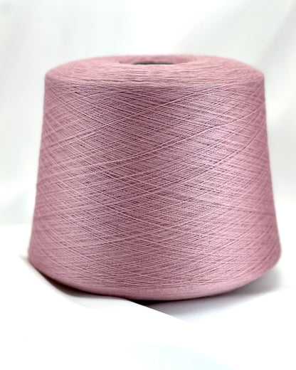 Pink spool of yarn on a white background