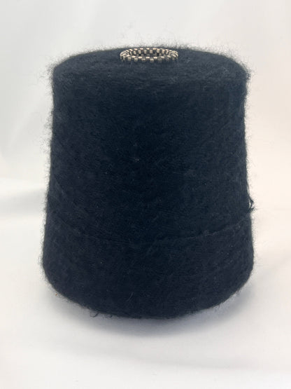 Black yarn cone on a white background