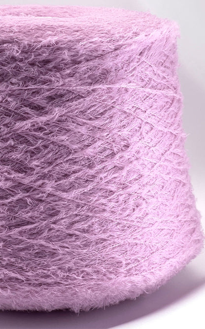 Close-up of a pink skein of yarn on a white background