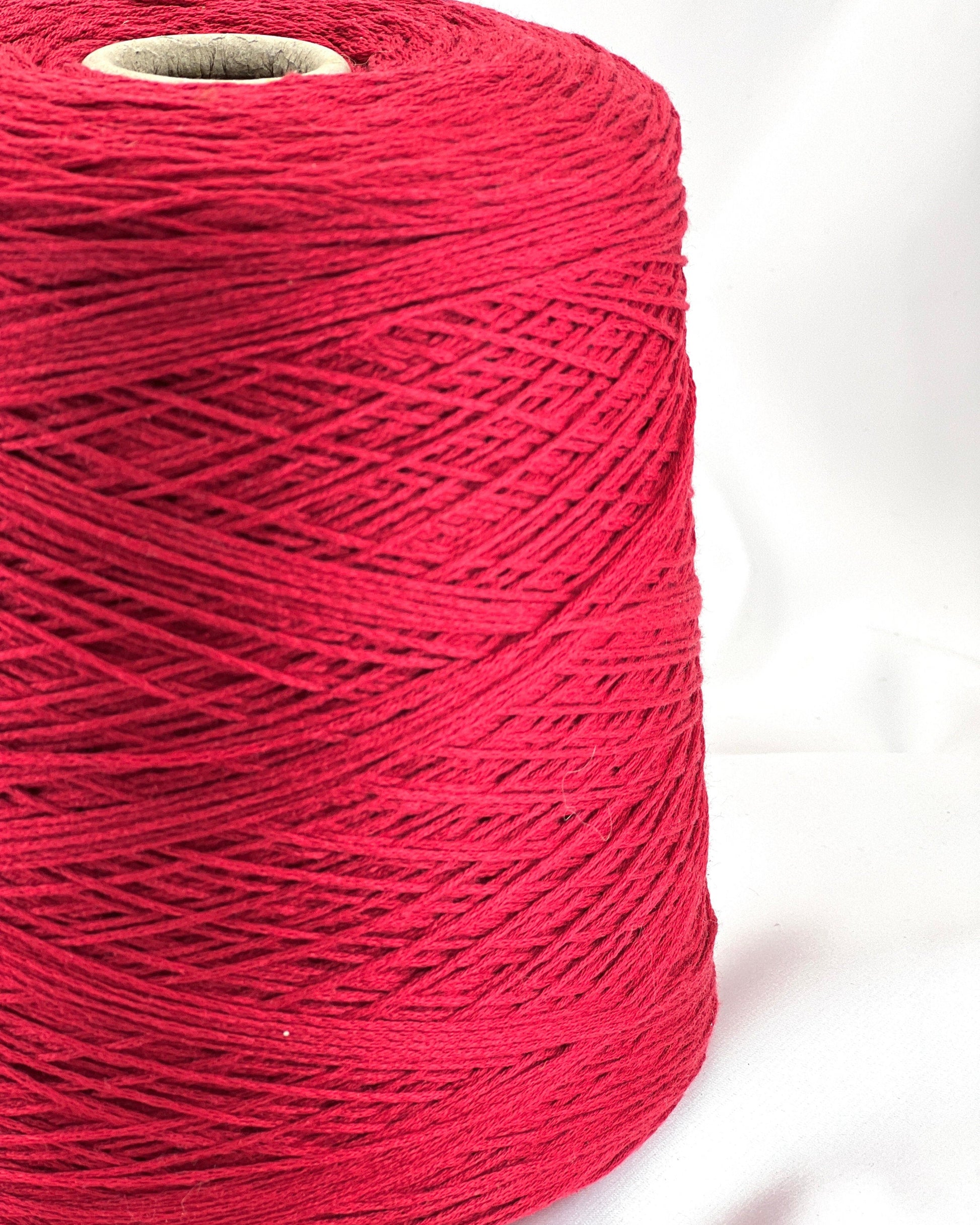 Spool of red thread on a white background