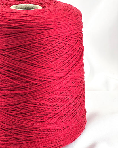 Spool of red thread on a white background