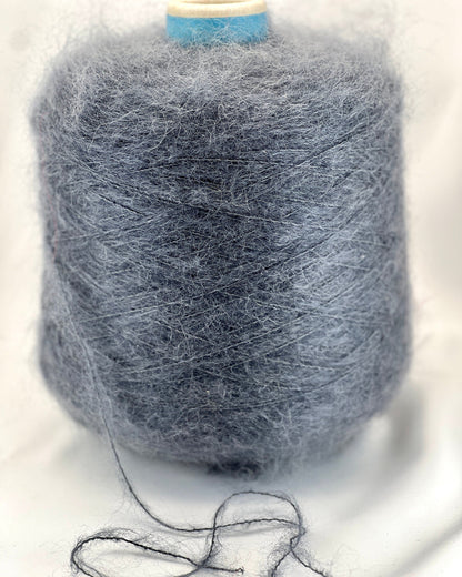 Spool of gray yarn on a white background