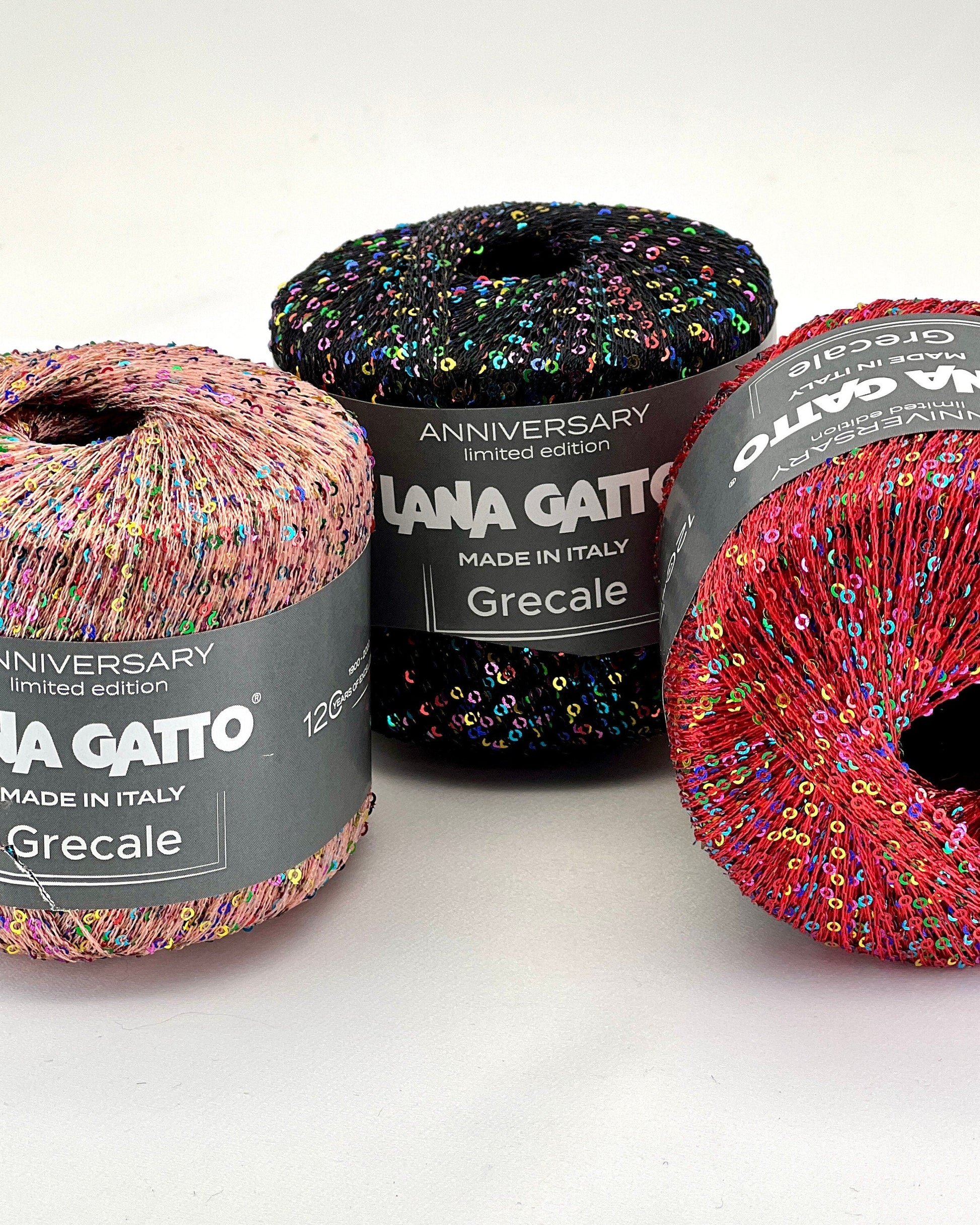 Three skeins of colorful yarn with 'Lana Gatto' labels on a white background