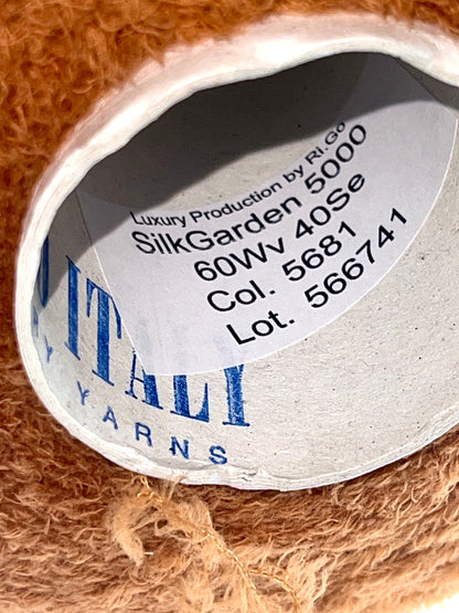 Close-up of a label on a ball of yarn with brand and product details.