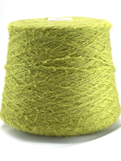Spool of green yarn on a white background