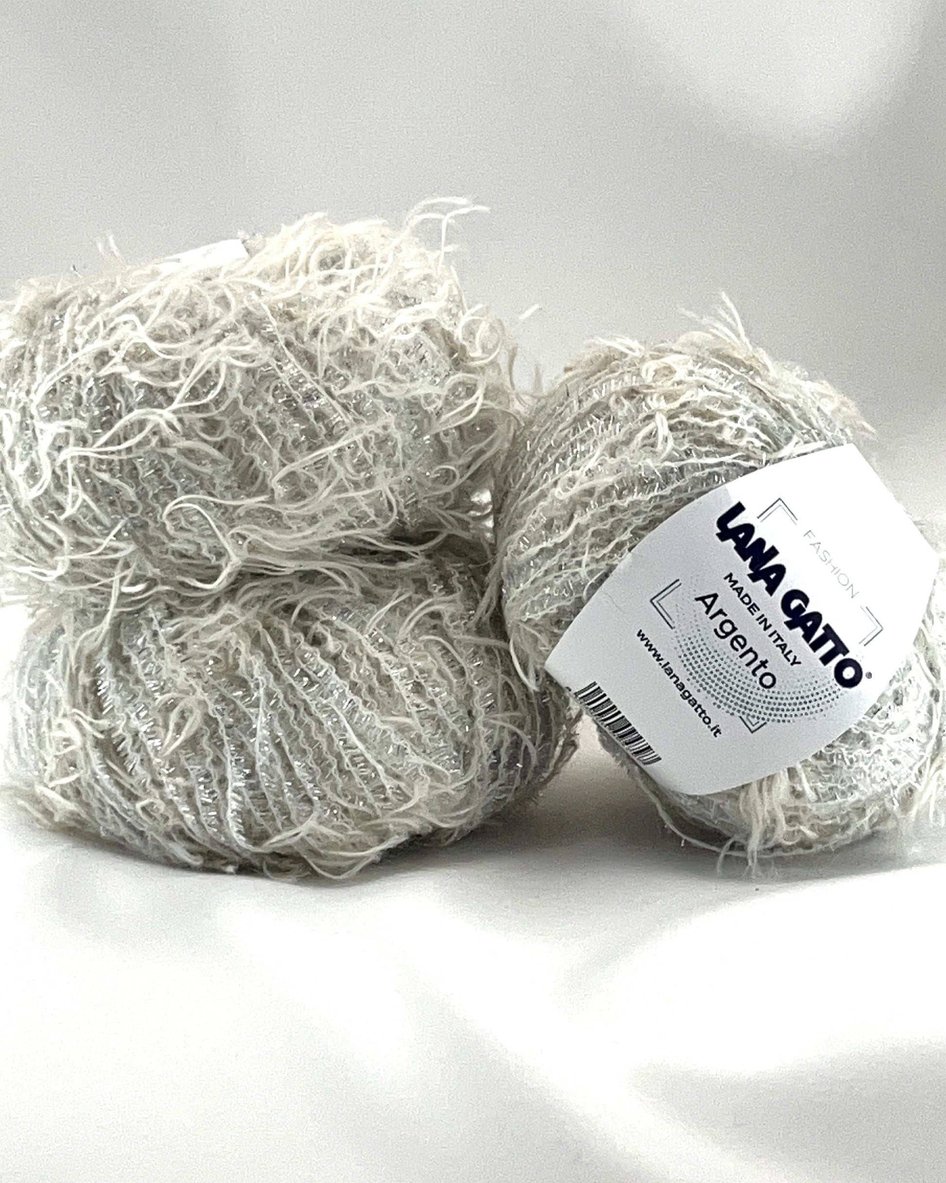 Two balls of yarn with a label on a white background
