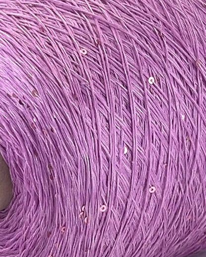 Close-up of a purple yarn ball with visible fibers