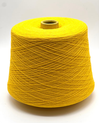 Yellow spool of thread on a white background