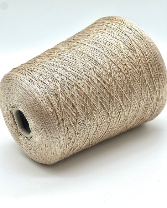 Spool of beige yarn on a white background