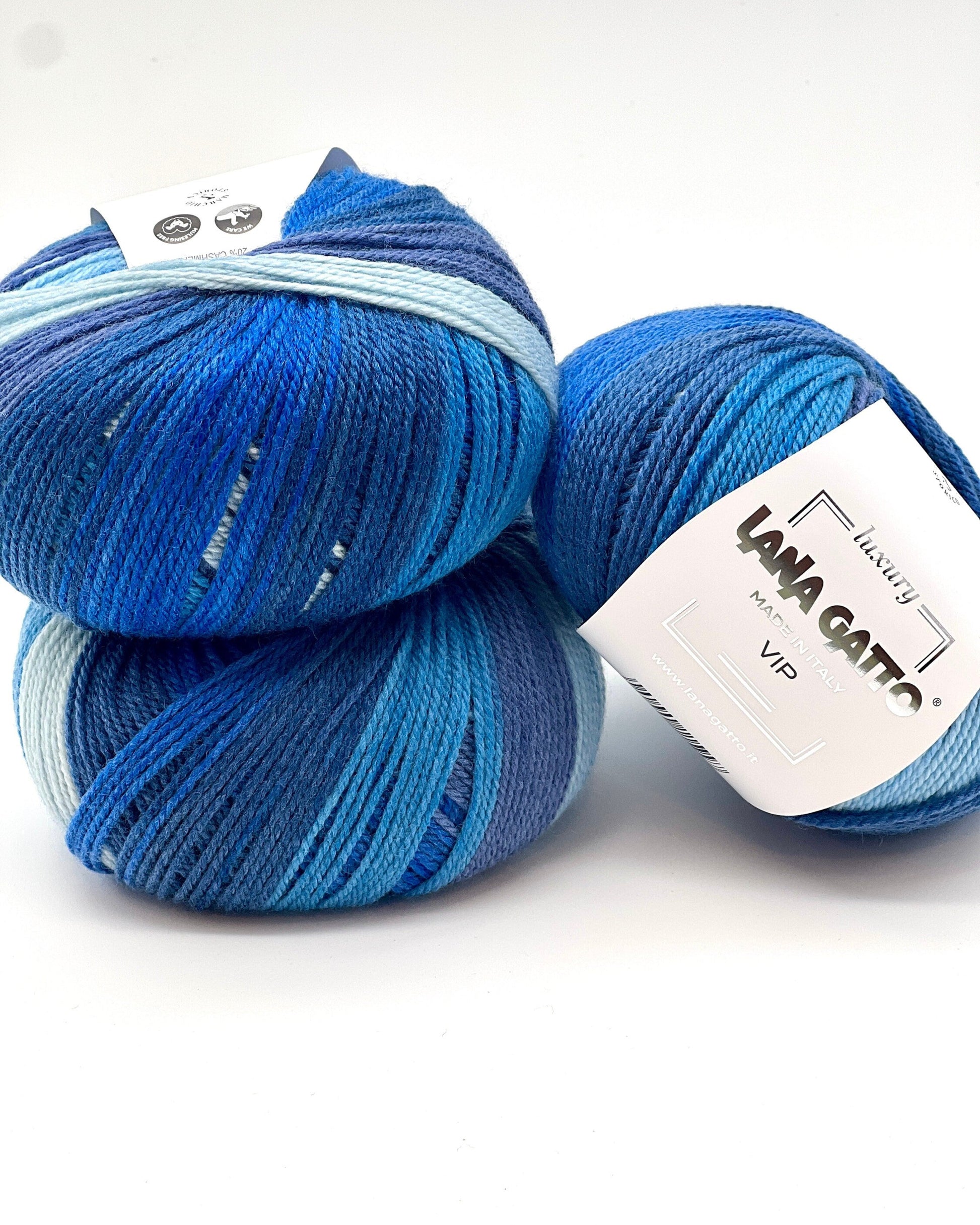 Two blue skeins of yarn with a visible label on a white background