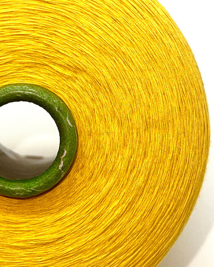 YUMA by Prisma Ricerche — sunflower yellow ecological lace-weight cable cotton yarn, shown on cone and in texture close-ups, available at iDOKNiT.