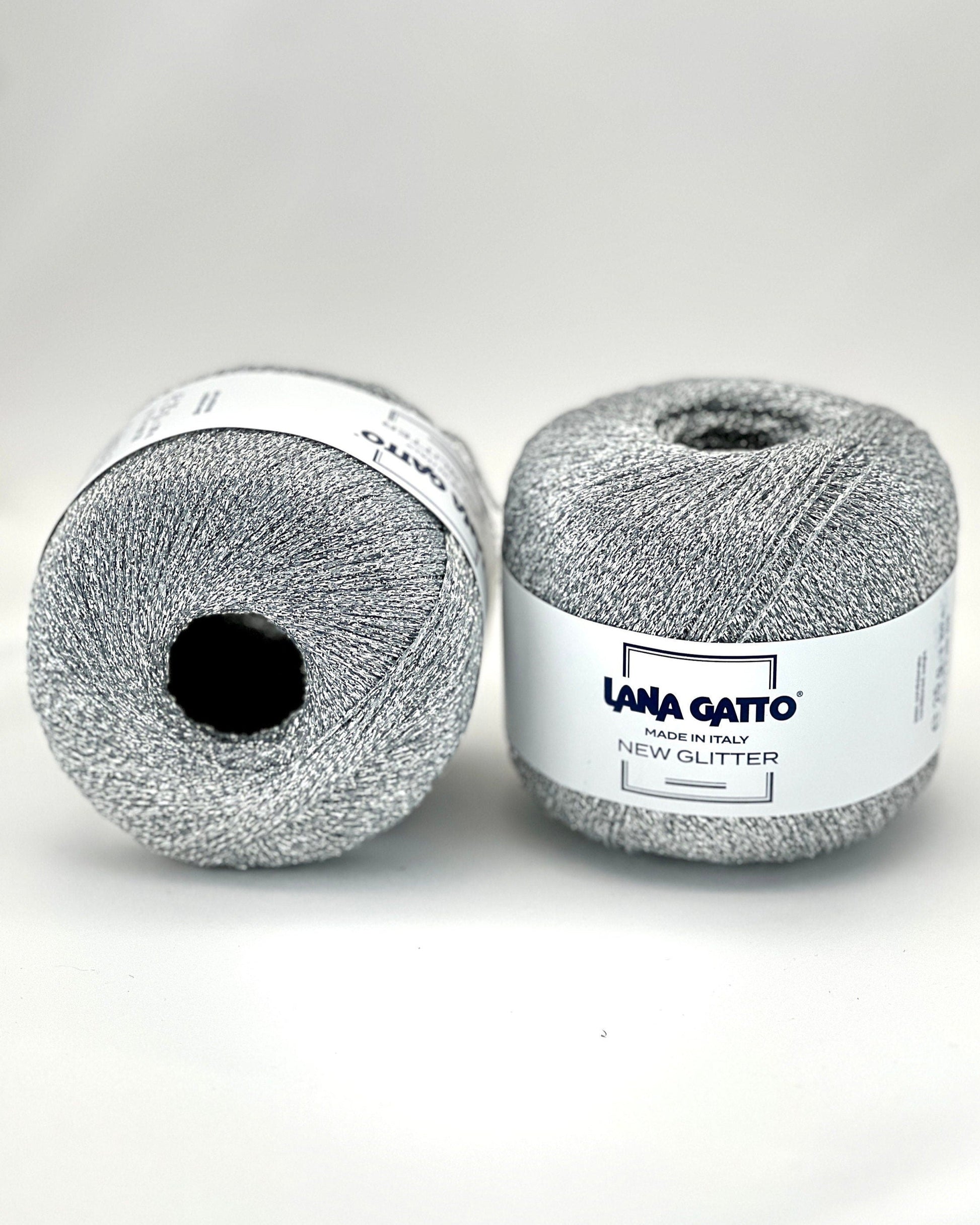 Two balls of gray yarn with a label on a white background