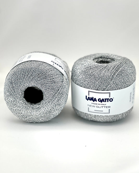 Two balls of gray yarn with a label on a white background
