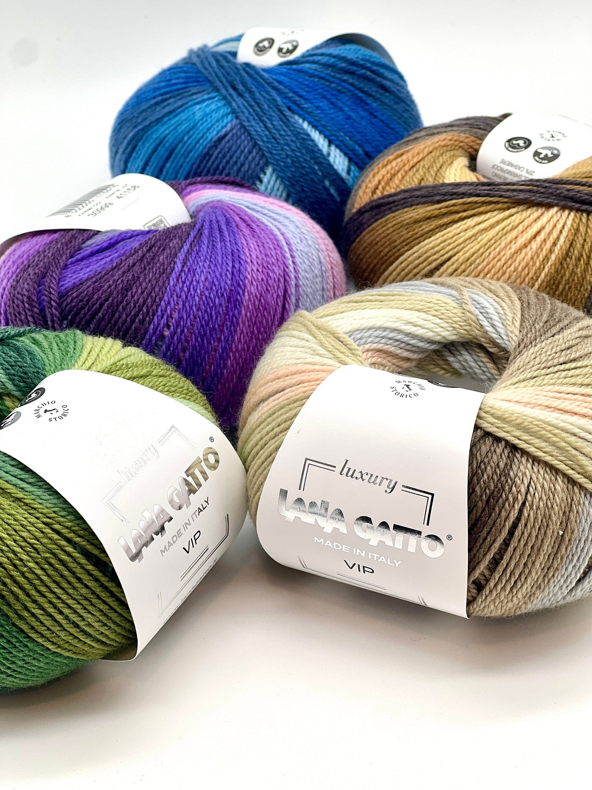 Assorted skeins of yarn in various colors with 'Lana Grossa' labels on a white background.