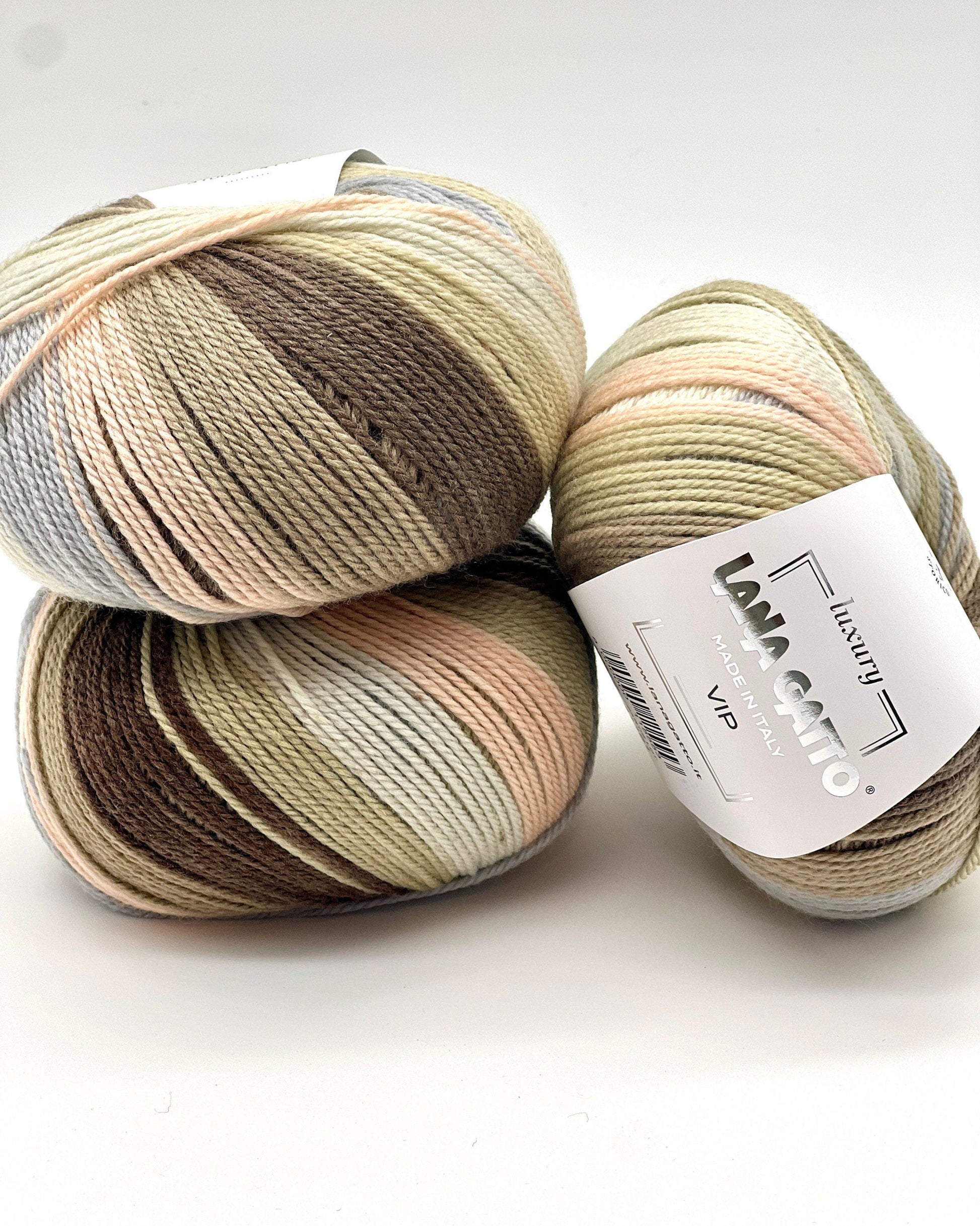Three skeins of multicolored yarn with a label on a white background