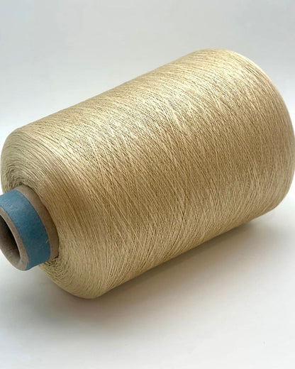 Spool of beige thread on a white background