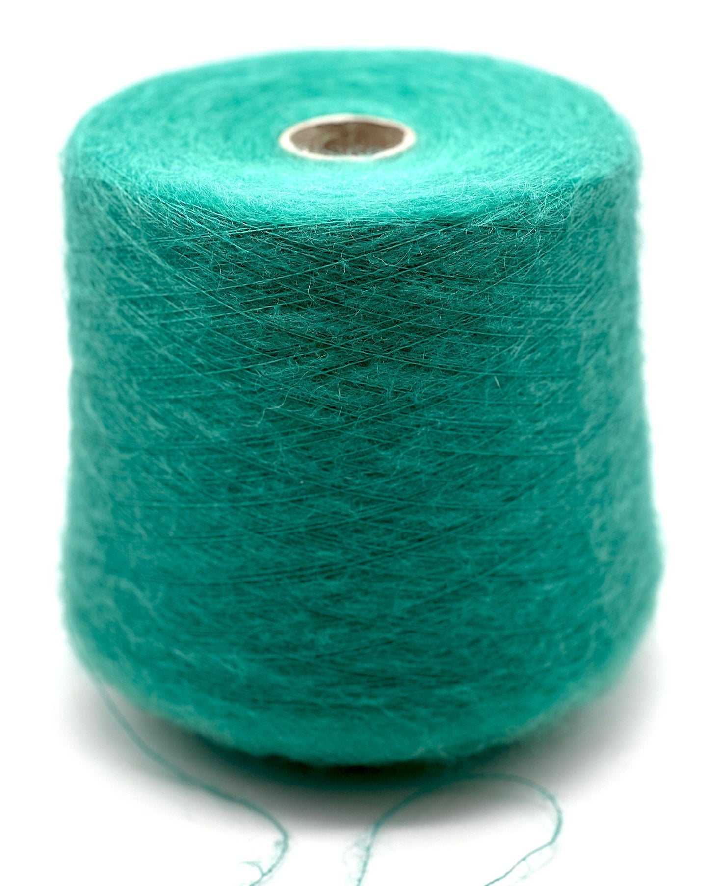 Turquoise yarn spool on a white background
