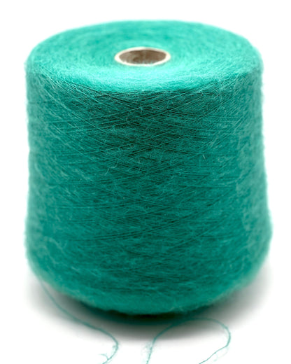 Turquoise yarn spool on a white background