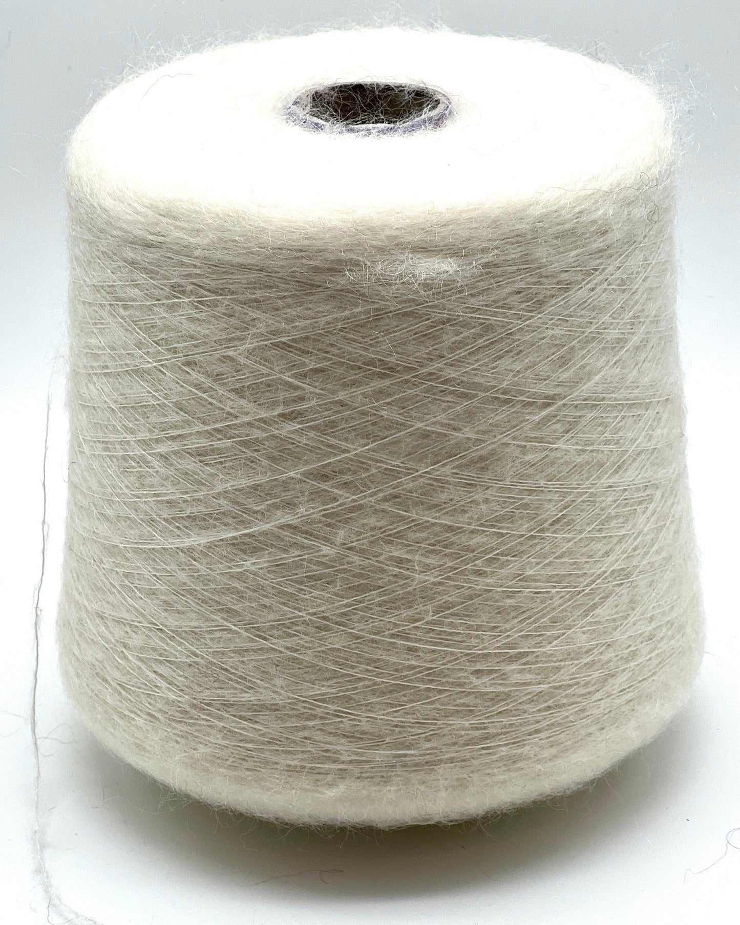 Spool of white yarn on a white background