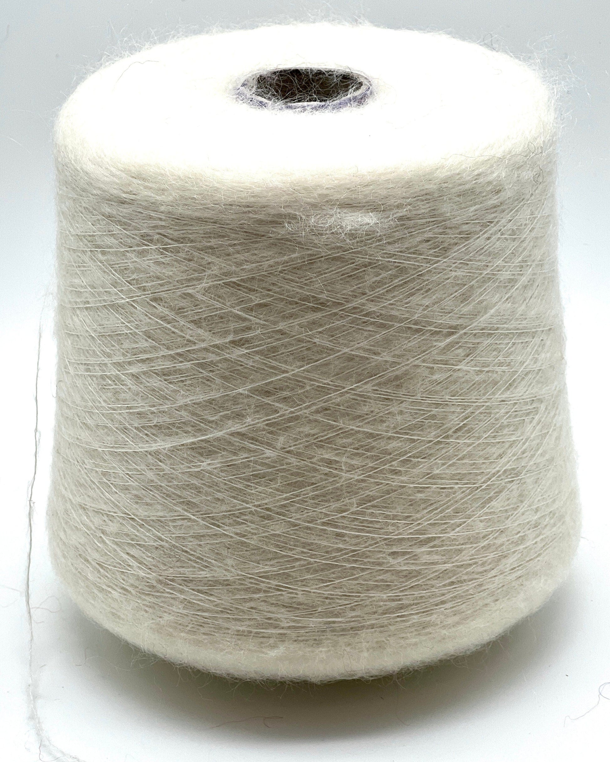 Spool of white yarn on a white background