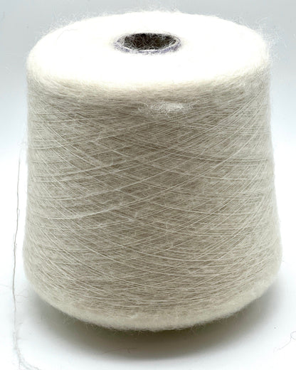 Spool of white yarn on a white background