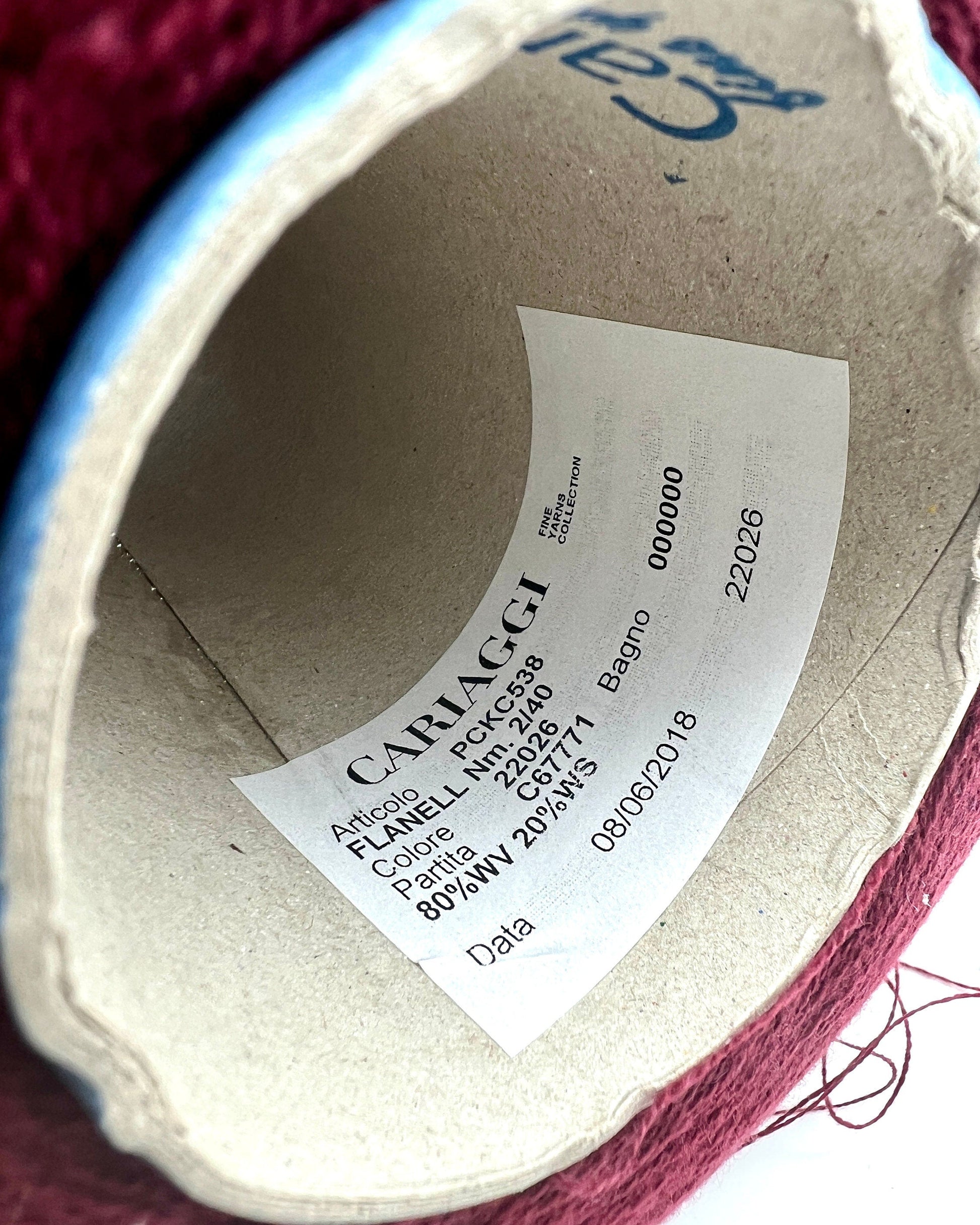 Close-up of a Cariaggi label on a fabric product with visible yarn.