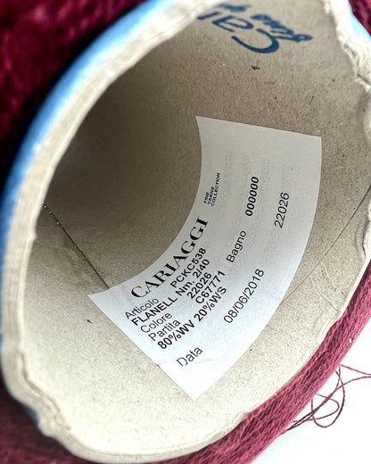 Close-up of a Cariaggi label on a fabric product with visible yarn.