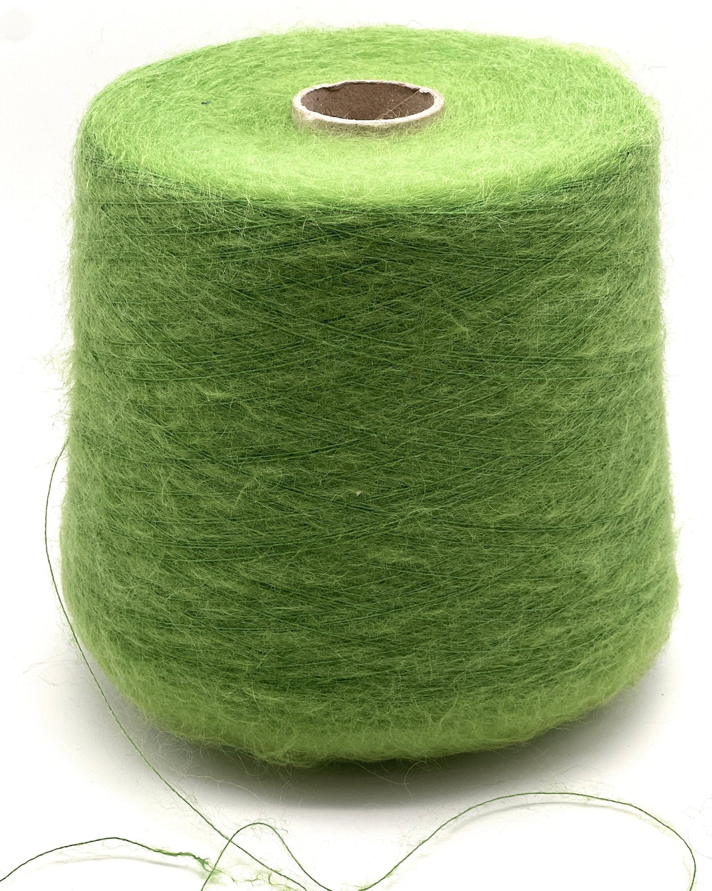 Green spool of yarn on a white background