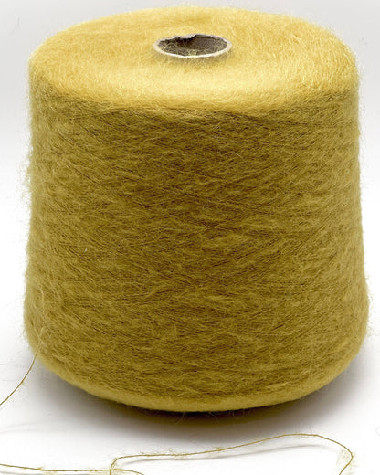 Spool of yellow yarn on a white background