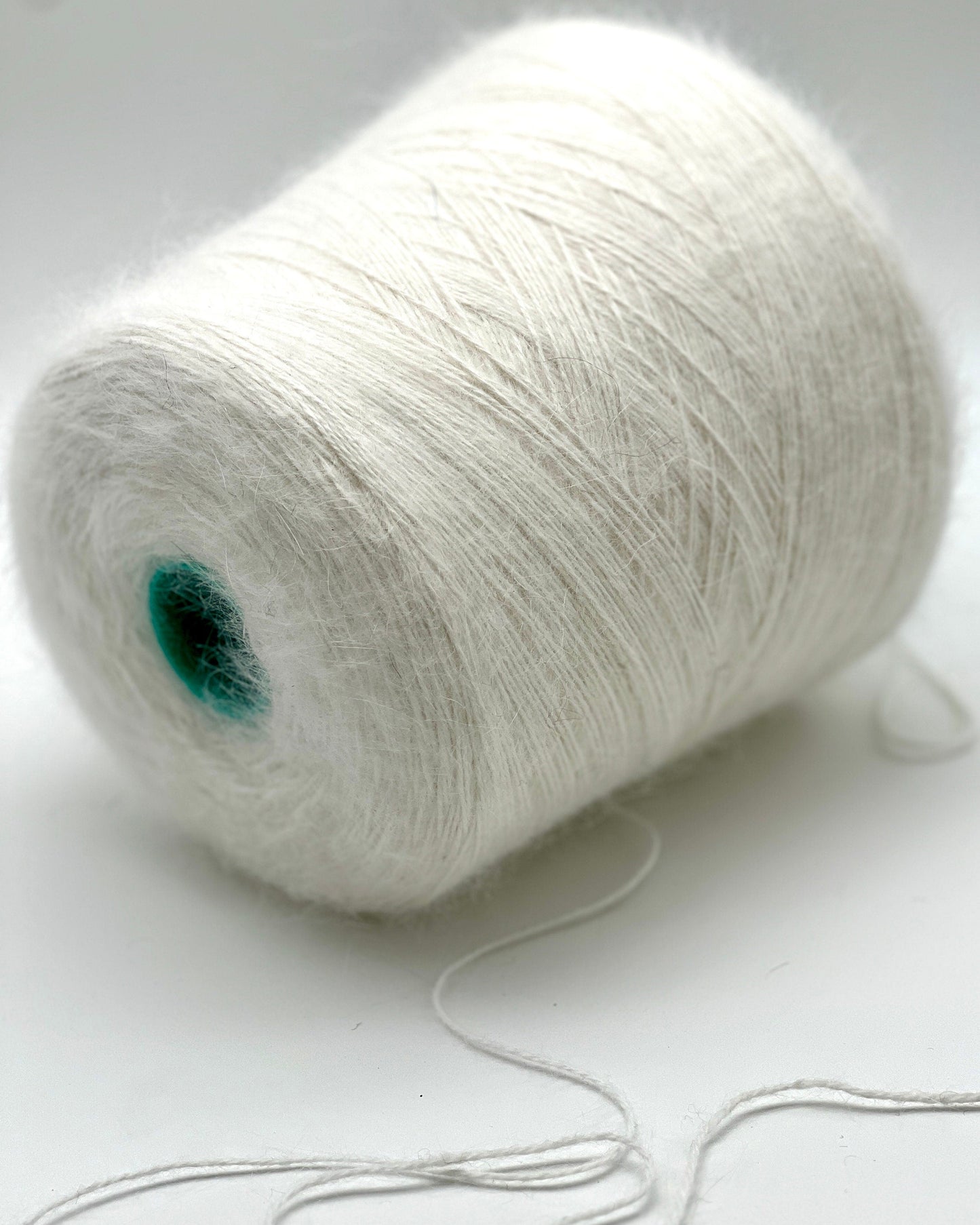 White yarn spool on a white background