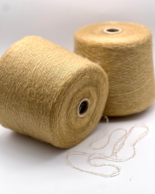 Two spools of beige twine on a white background