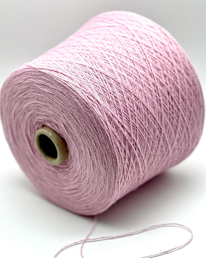 Pink spool of yarn on a white background