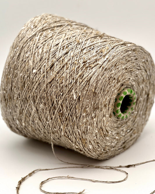 Spool of natural fiber string on a white background