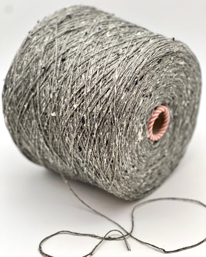 Ball of gray yarn with a pink knot on a white background