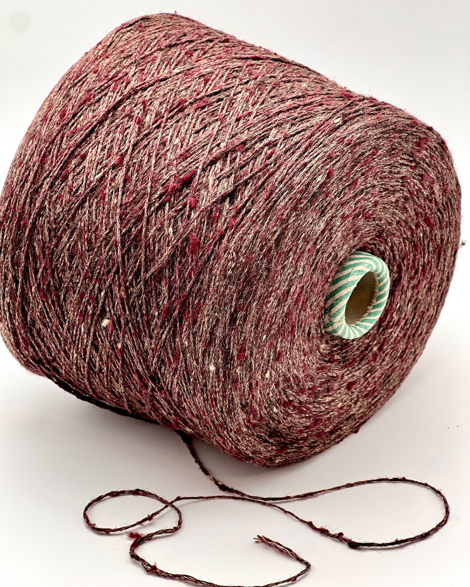 Spool of red yarn on a white background