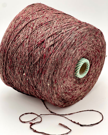 Spool of red yarn on a white background
