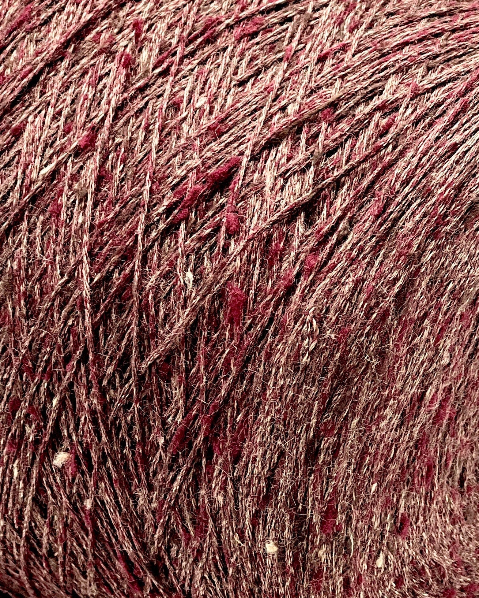 Close-up of a ball of red yarn with speckles