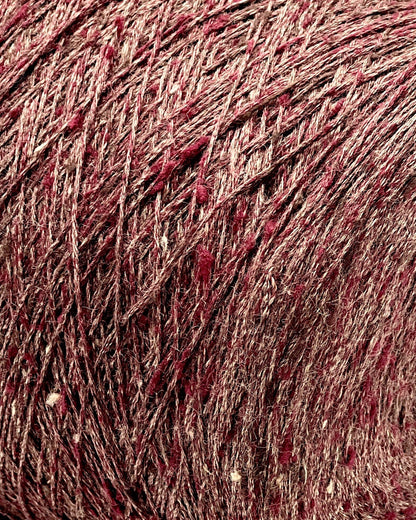 Close-up of a ball of red yarn with speckles