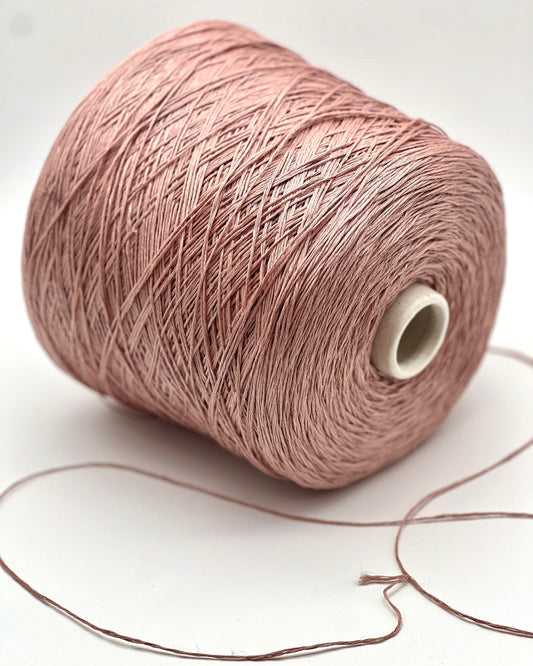 Spool of pink yarn on a white background
