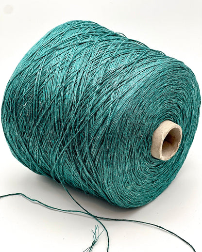Teal spool of yarn on a white background