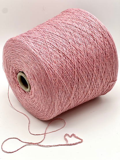 Pink spool of yarn on a white background