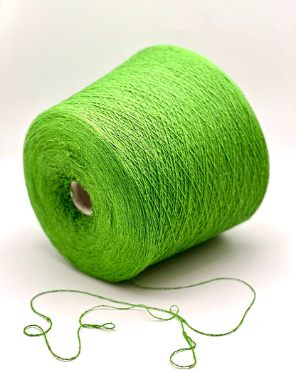 Green spool of yarn on a white background