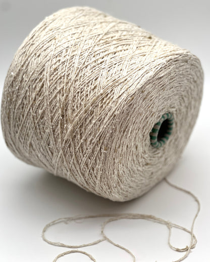 Spool of beige yarn on a white background