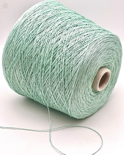 Spool of light green yarn on a white background