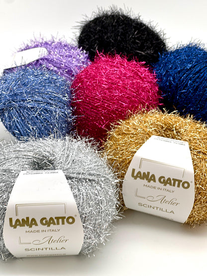Colorful yarn balls with 'Lana Gatto' labels on a white background