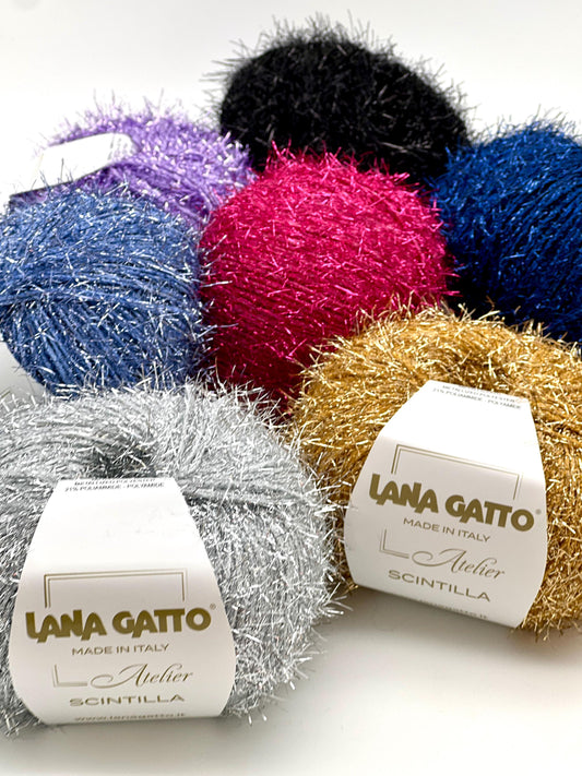Colorful yarn balls with 'Lana Gatto' labels on a white background